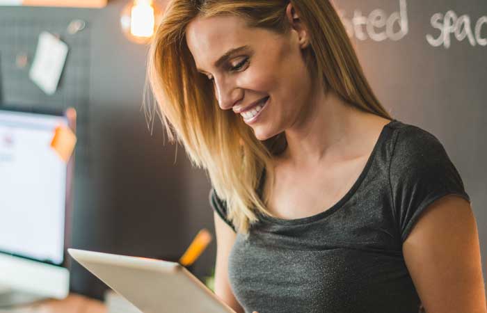 Woman smiling at tablet