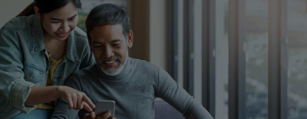 Couple smiling at phone