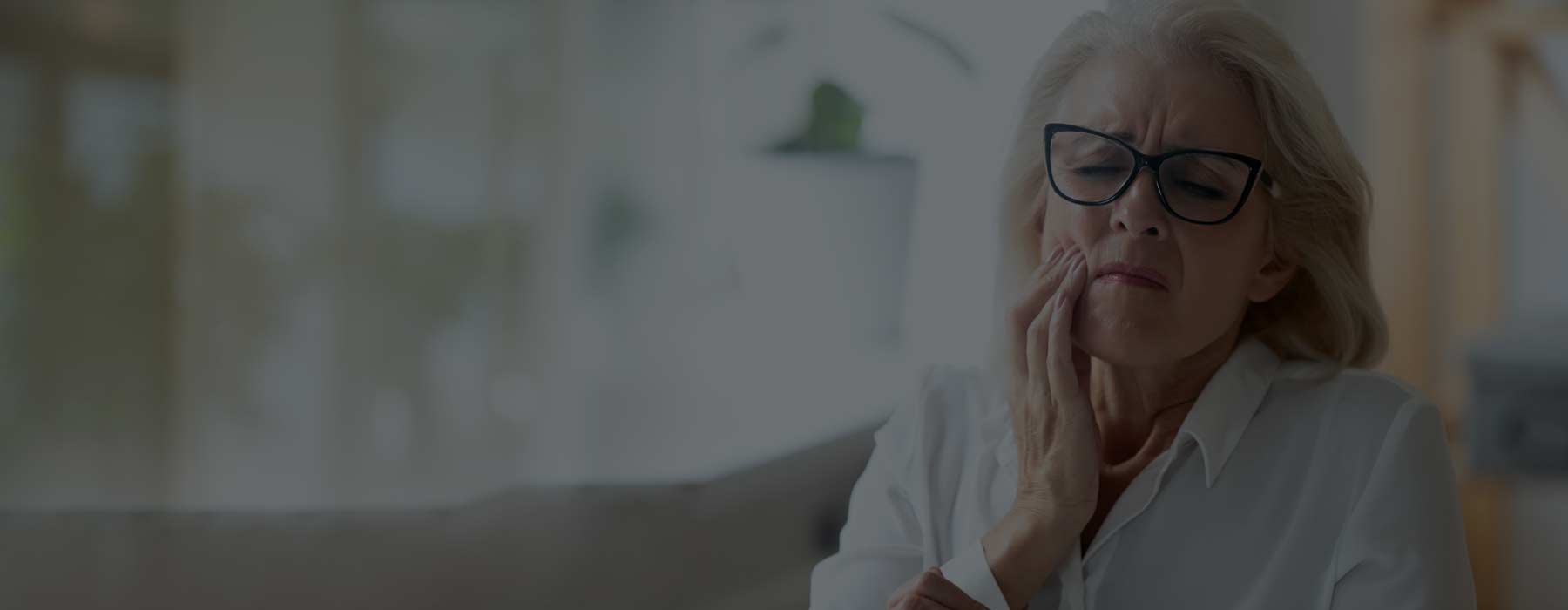 Woman holding face in pain